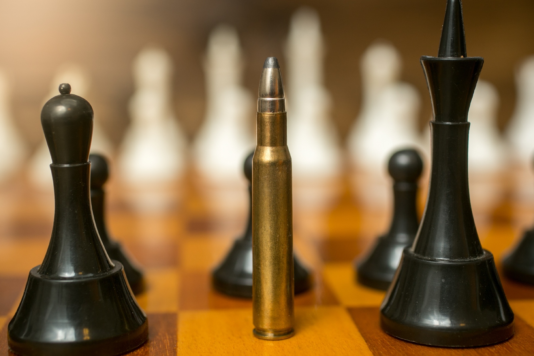 closeup-of-bullet-standing-on-place-of-queen-chess-2023-11-27-04-58-46-utc-1