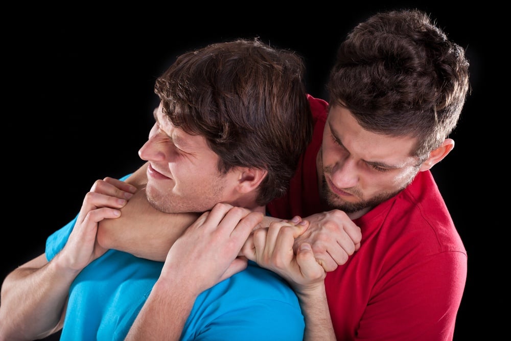 Fighting men friends on isolated black background