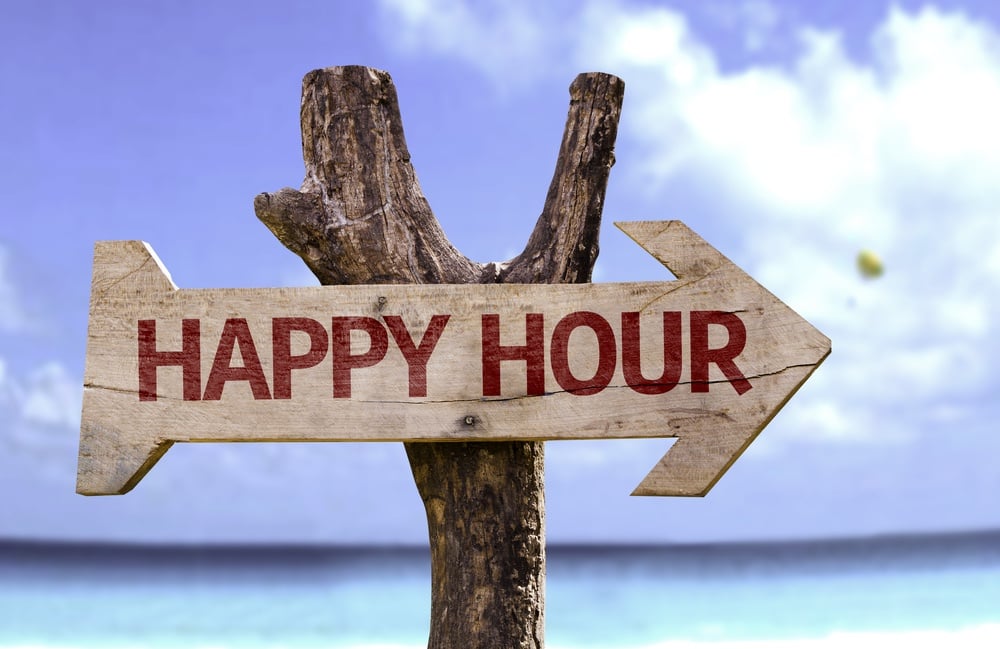 Happy Hour wooden sign with a beach on background