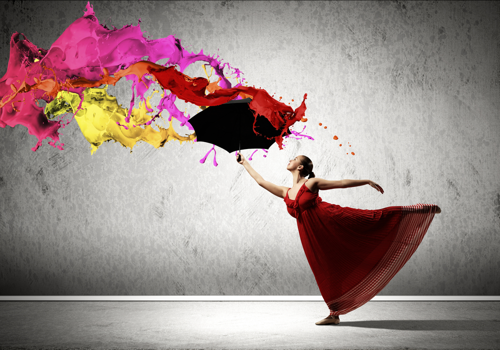 ballet dancer in flying satin dress with umbrella under the paint